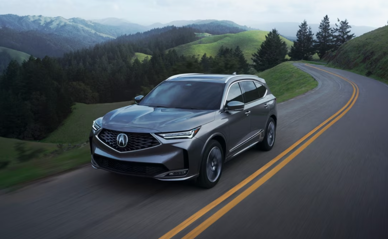 A gray used Acura driving through the mountains
