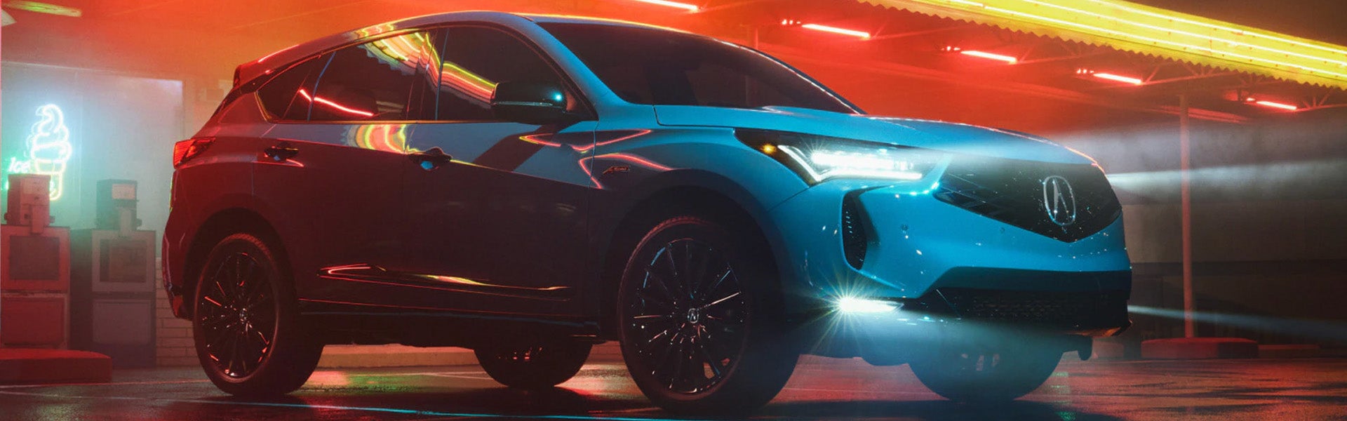side view of the New Acura RDX parked in red ambient lighting