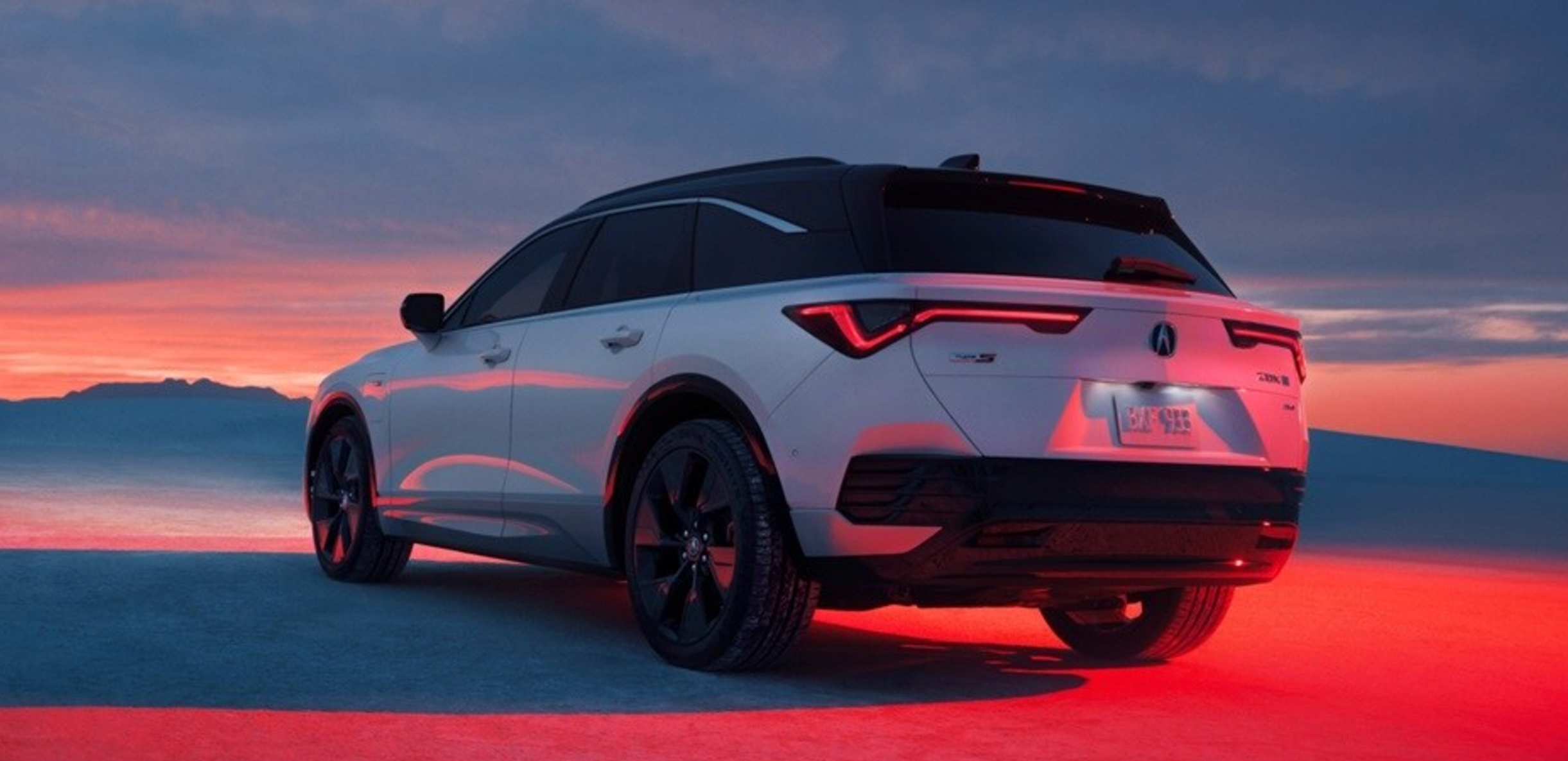 rear view of the New Acura ZDX parked in red ambient lighting